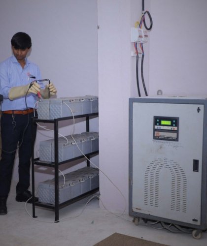 Avani Sales & Service engineer testing a servo voltage stabilizer