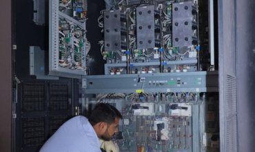 Avani Sales technician repairing industrial online UPS system